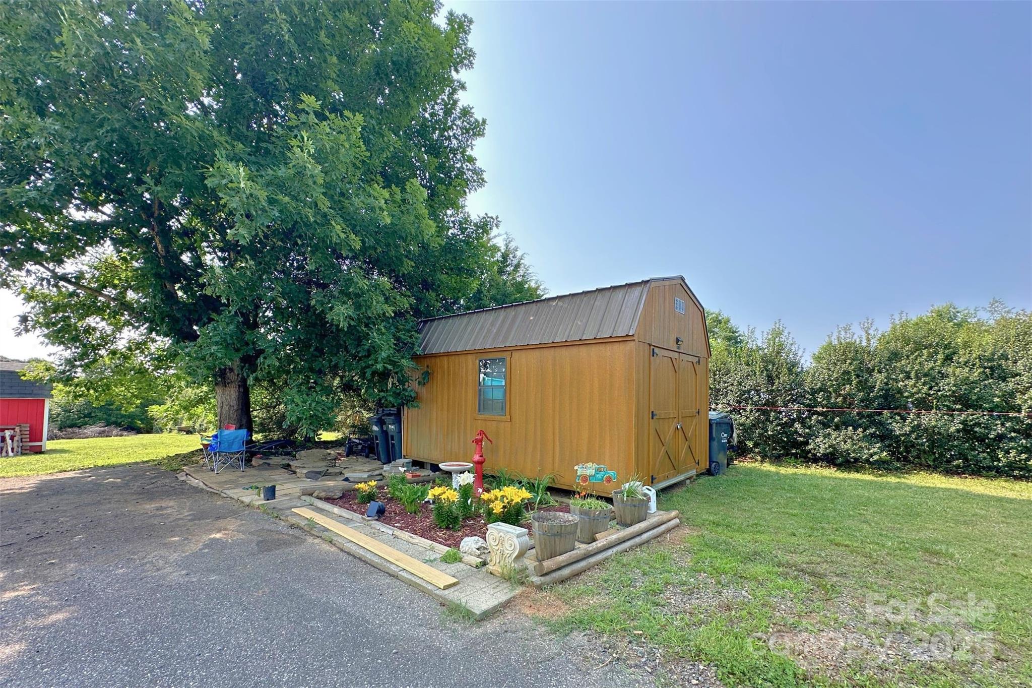 2449 Leonhart Road Cherryville, NC 28021 - Photo 20 of 21 a backyard of a house with garden and garage