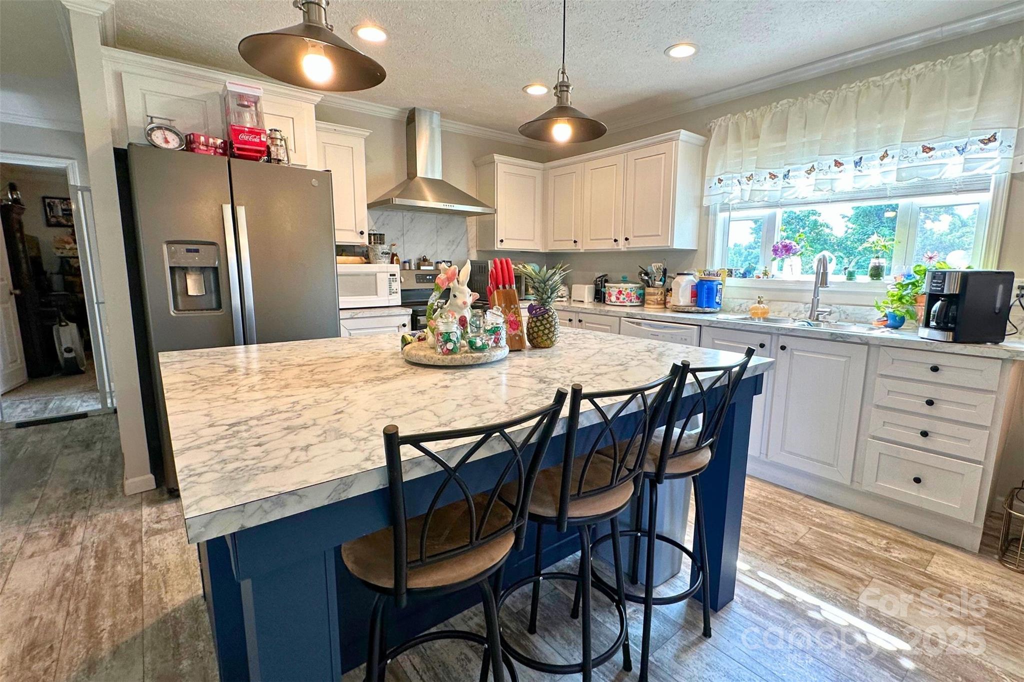 2449 Leonhart Road Cherryville, NC 28021 - Photo 3 of 21 a kitchen with stainless steel appliances kitchen island granite countertop a dining table chairs and a refrigerator
