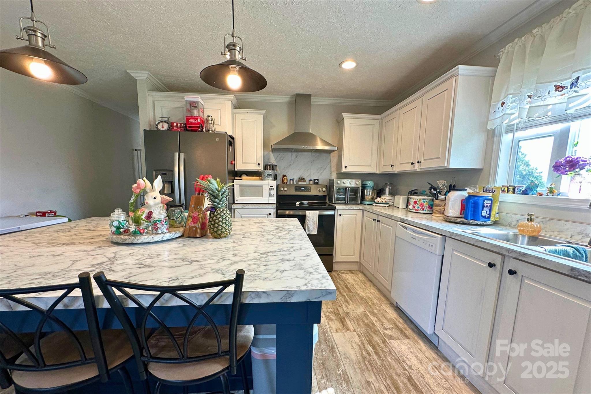 2449 Leonhart Road Cherryville, NC 28021 - Photo 4 of 21 a kitchen with granite countertop wooden floor cabinets dining table and chairs