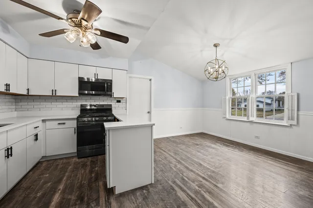a kitchen with stainless steel appliances granite countertop a stove sink and microwave