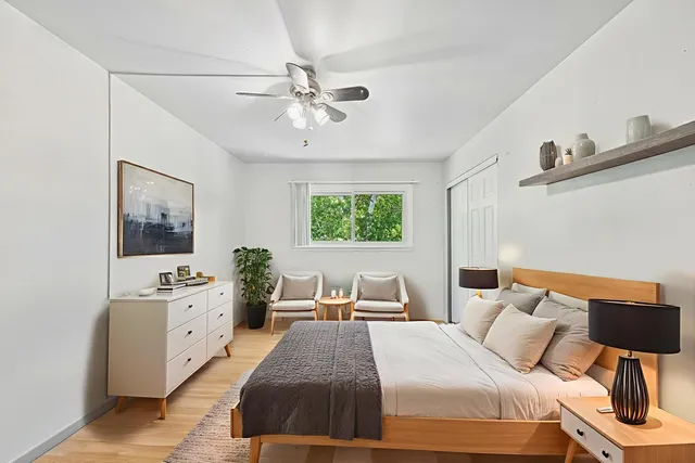 a bedroom with a large bed and a chandelier