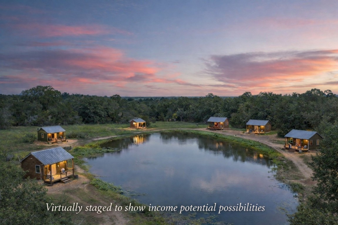 an aerial view of a house with a lake view