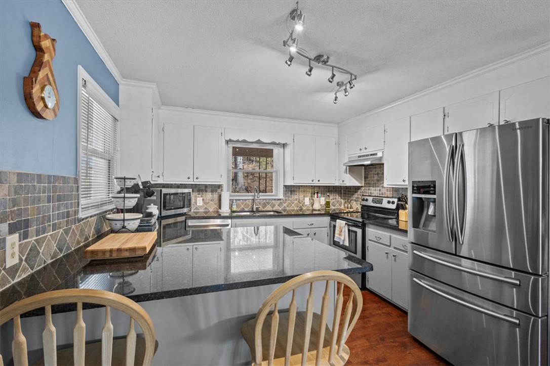 310 Trussel View Road Anderson, SC 29625 - Photo 6 of 35 Kitchen with granite, ceramic backsplash, and brea