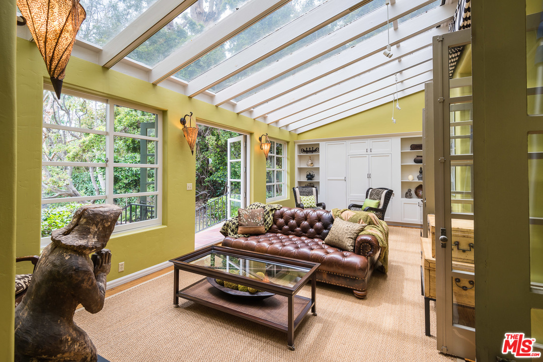 12730 Sunset Boulevard Los Angeles, CA 90049 - Photo 17 of 51 a living room with furniture and floor to ceiling windows