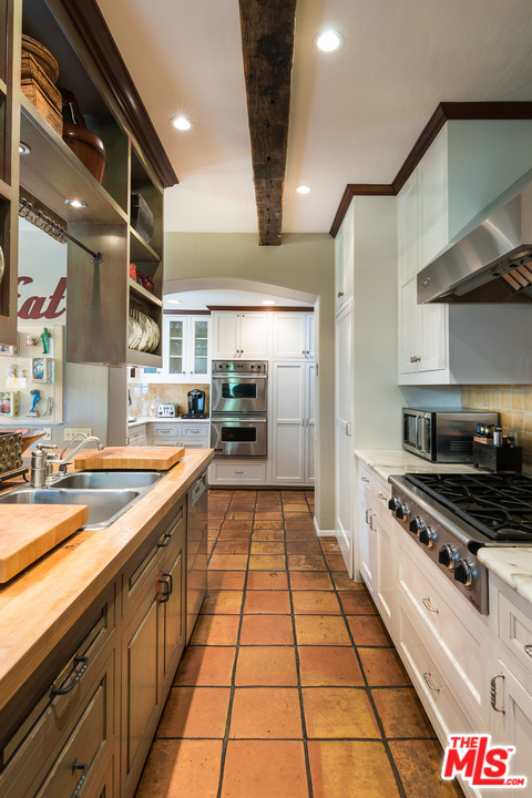 12730 Sunset Boulevard Los Angeles, CA 90049 - Photo 24 of 51 a large kitchen with stainless steel appliances granite countertop a large stove a sink and cabinets
