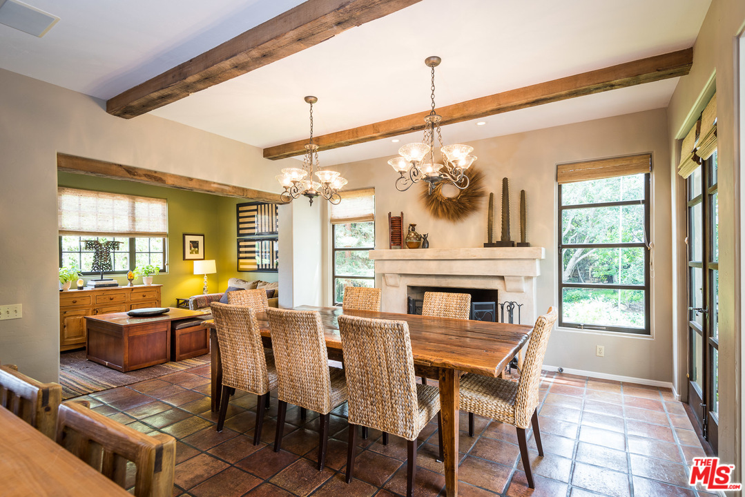 12730 Sunset Boulevard Los Angeles, CA 90049 - Photo 25 of 51 a dining room with furniture a chandelier and wooden floor