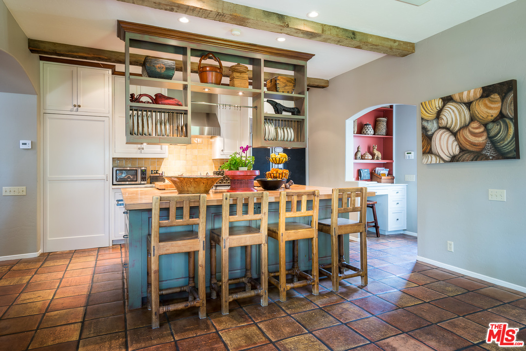 12730 Sunset Boulevard Los Angeles, CA 90049 - Photo 26 of 51 a dining room with furniture and a floor to ceiling window