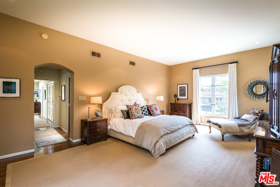12730 Sunset Boulevard Los Angeles, CA 90049 - Photo 32 of 51 a bedroom with a bed and large windows