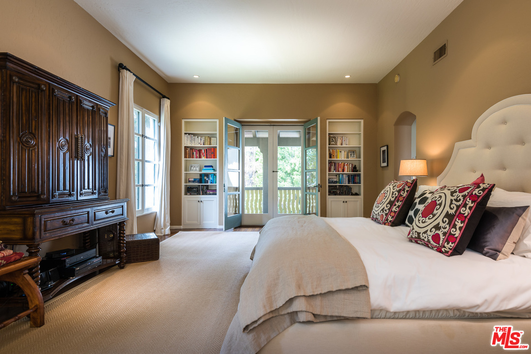 12730 Sunset Boulevard Los Angeles, CA 90049 - Photo 34 of 51 a bedroom with a bed and dresser with floor to ceiling window