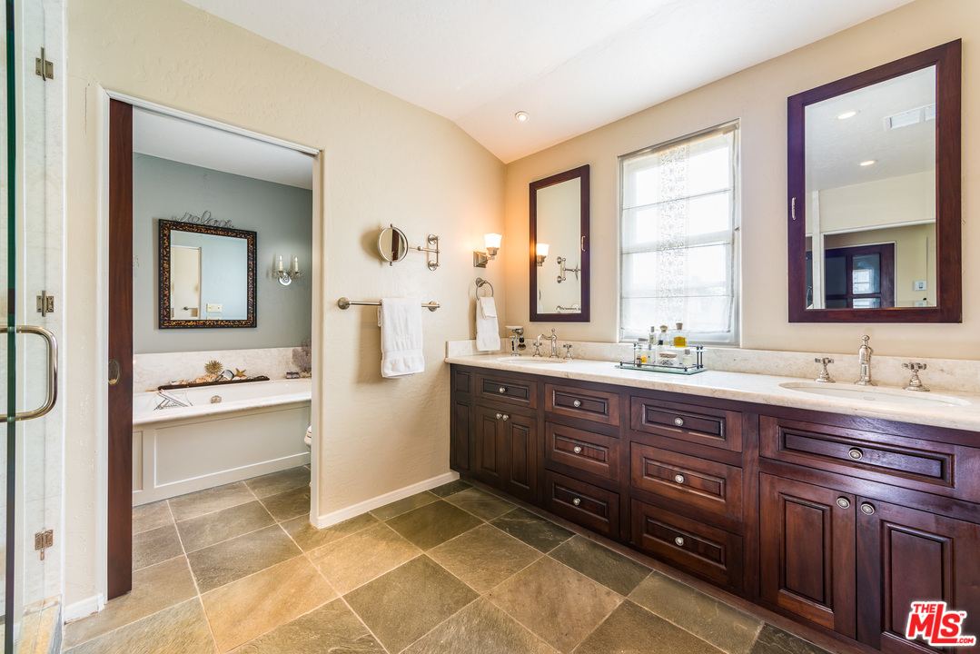 12730 Sunset Boulevard Los Angeles, CA 90049 - Photo 35 of 51 a spacious bathroom with a tub sink and mirror