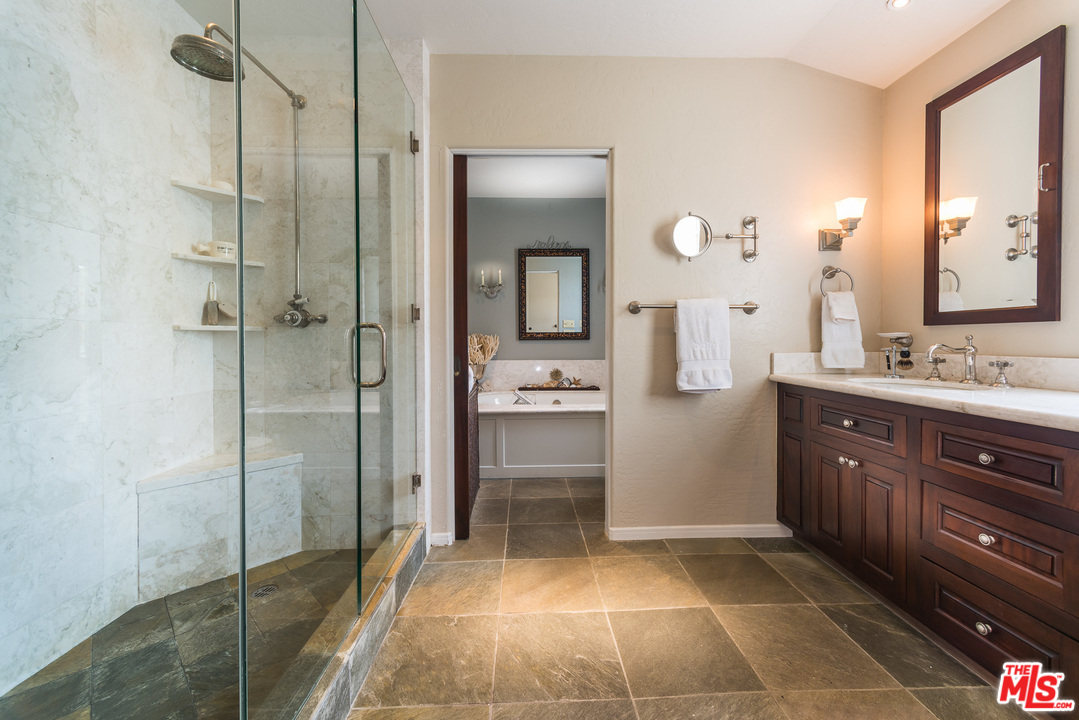 12730 Sunset Boulevard Los Angeles, CA 90049 - Photo 36 of 51 a bathroom with a sink a toilet and mirror