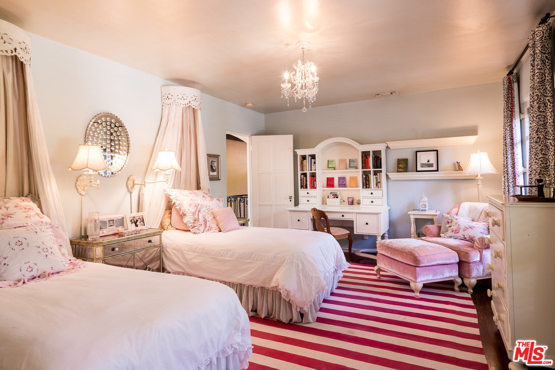 12730 Sunset Boulevard Los Angeles, CA 90049 - Photo 39 of 51 a bedroom with two beds and a chandelier