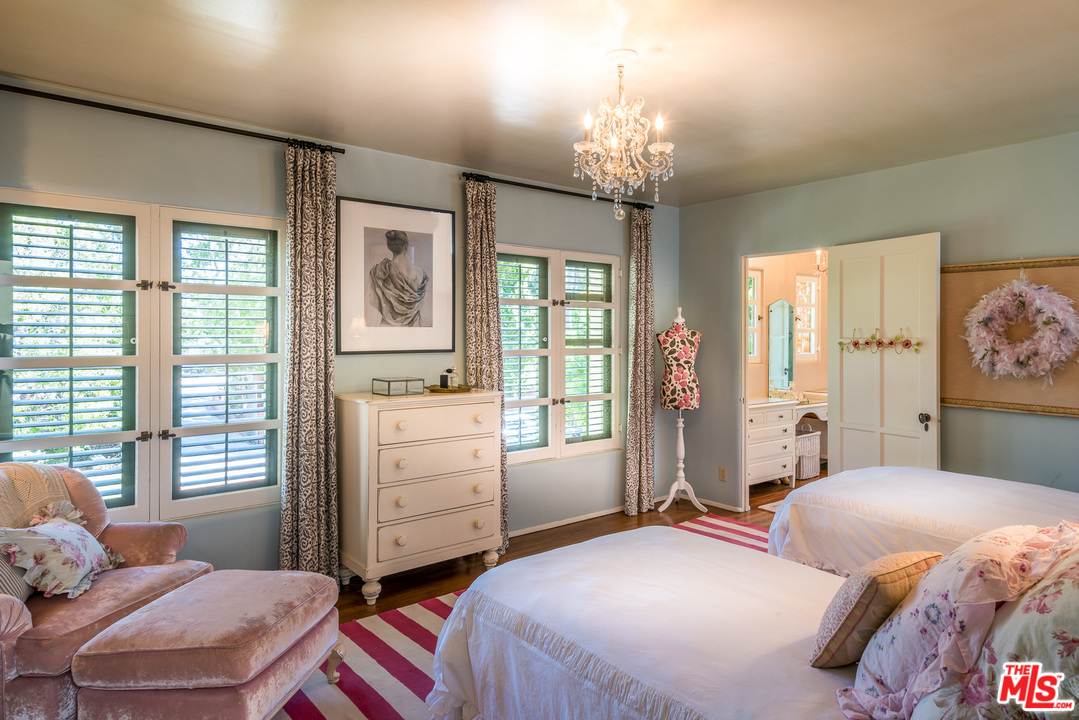 12730 Sunset Boulevard Los Angeles, CA 90049 - Photo 40 of 51 a bedroom with a bed and a chandelier