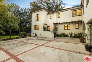 12730 Sunset Boulevard Los Angeles, CA 90049 - Photo 46 of 51 a front view of a house with a yard and garage