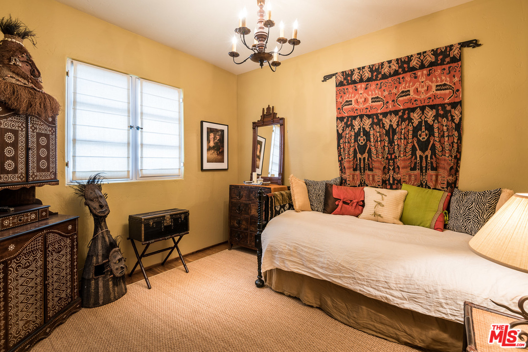 12730 Sunset Boulevard Los Angeles, CA 90049 - Photo 47 of 51 a bedroom with a bed and a chandelier
