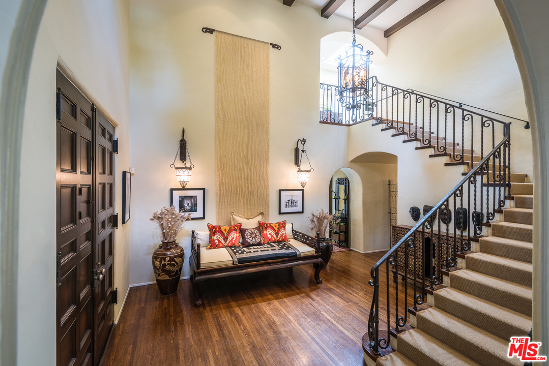12730 Sunset Boulevard Los Angeles, CA 90049 - Photo 10 of 51 a bedroom with furniture and a chandelier