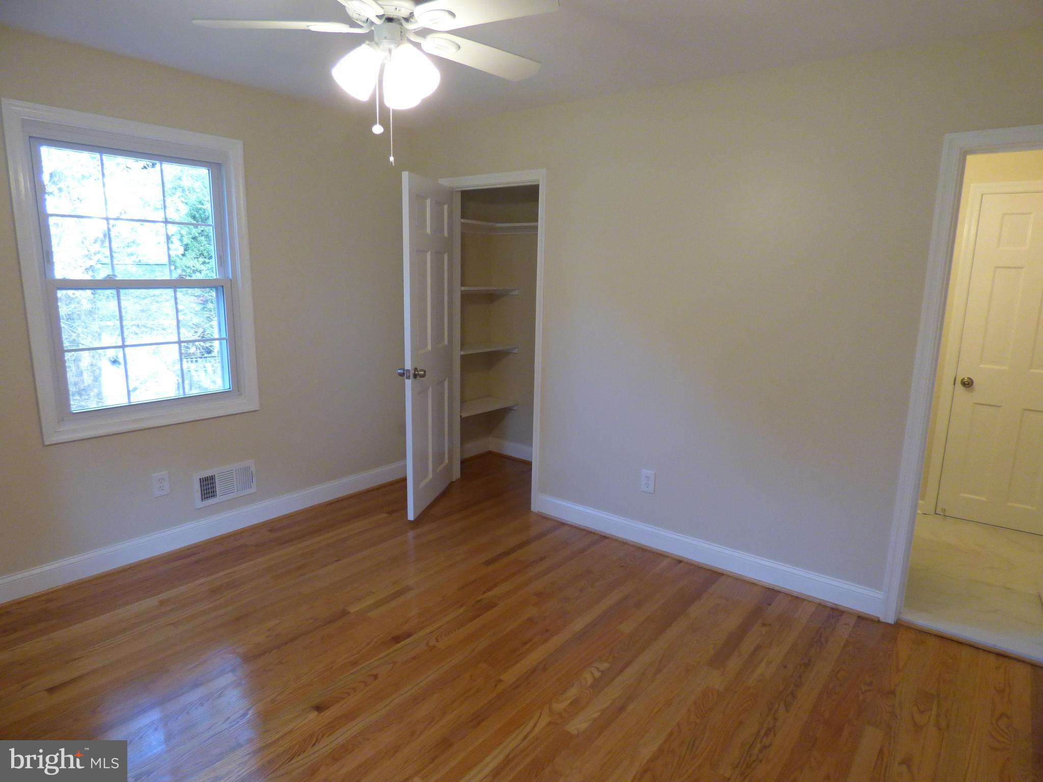 5033 Durham Road West Columbia, MD 21044 - Photo 14 of 30 a view of an empty room with wooden floor and a window