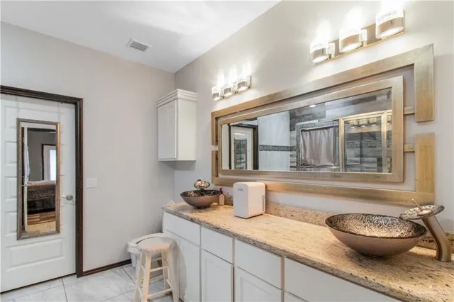 a kitchen with a sink and wooden floor