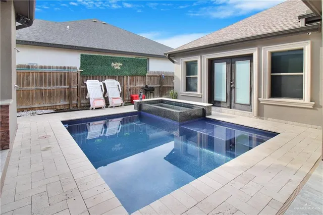 a swimming pool with outdoor seating