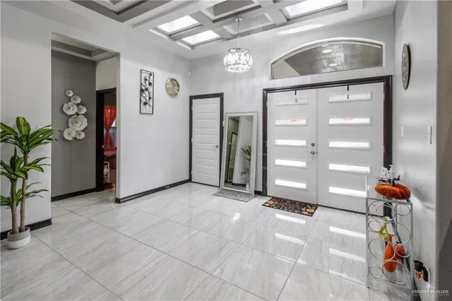 a view of empty room with windows and entryway