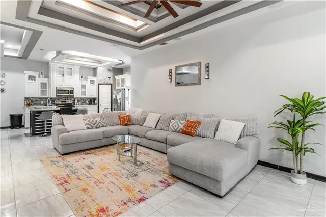 a living room with furniture and a chandelier