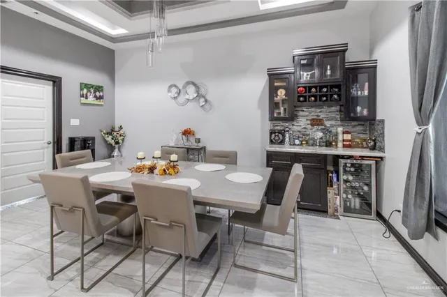 a dining room with a table and chairs