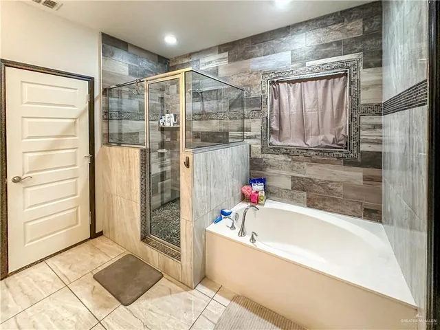 a bathroom with a bathtub and a shower
