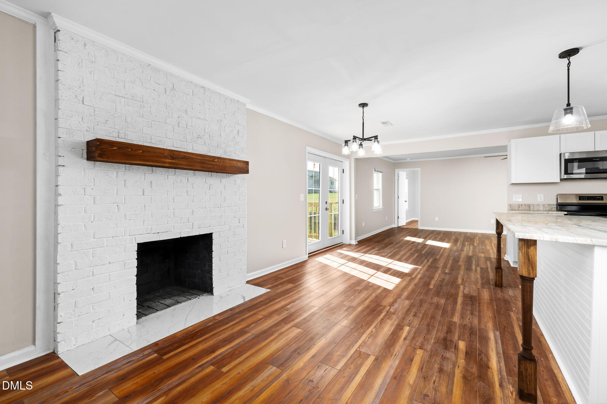 426 Rooker Dairy Road Norlina, NC 27563 - Photo 9 of 33 a open kitchen with a fireplace and wooden floor