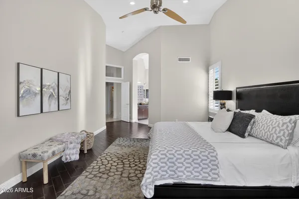 a bedroom with a large bed and a window