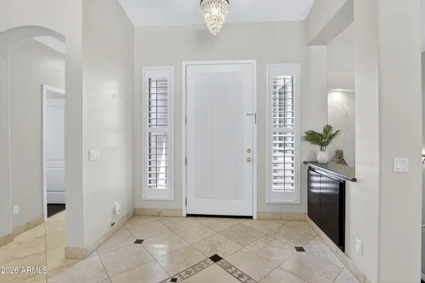 a kitchen with stainless steel appliances granite countertop a refrigerator a sink a stove and wooden cabinets