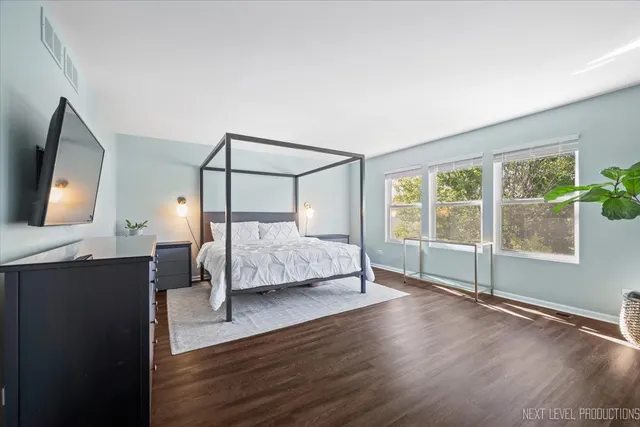 a spacious bathroom with a tub double sink and mirror