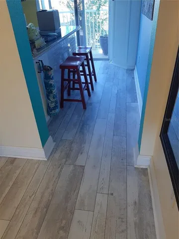 a view of a hardwood floor and an entryway