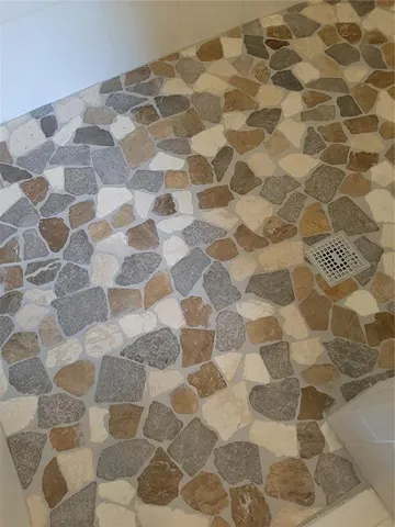 a bathroom with a bathtub and a shower