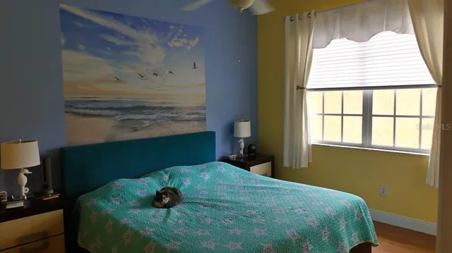 a bedroom with a bed and a window