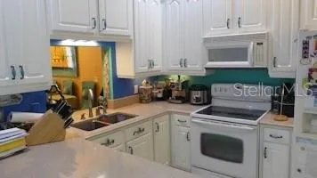 a kitchen with a stove microwave and cabinets