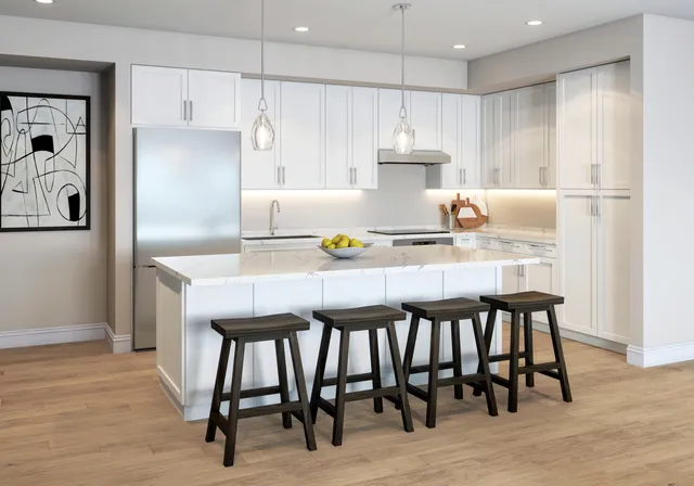a kitchen with a table chairs refrigerator and cabinets