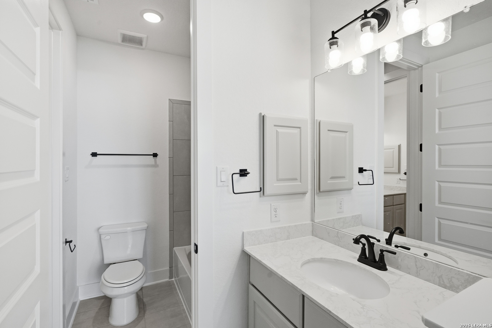 513 Corwin Springs Cibolo, TX 78108 - Photo 15 of 40 a bathroom with a sink a toilet and shower