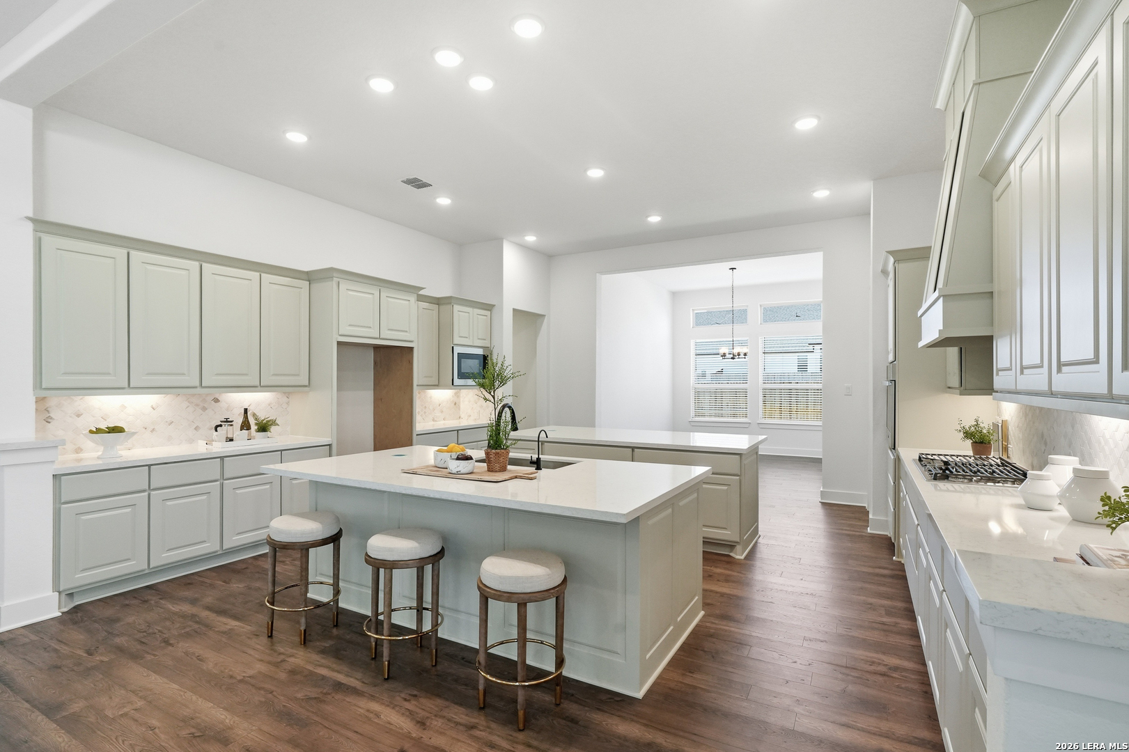 513 Corwin Springs Cibolo, TX 78108 - Photo 22 of 40 a kitchen with sink stove dining table and chairs