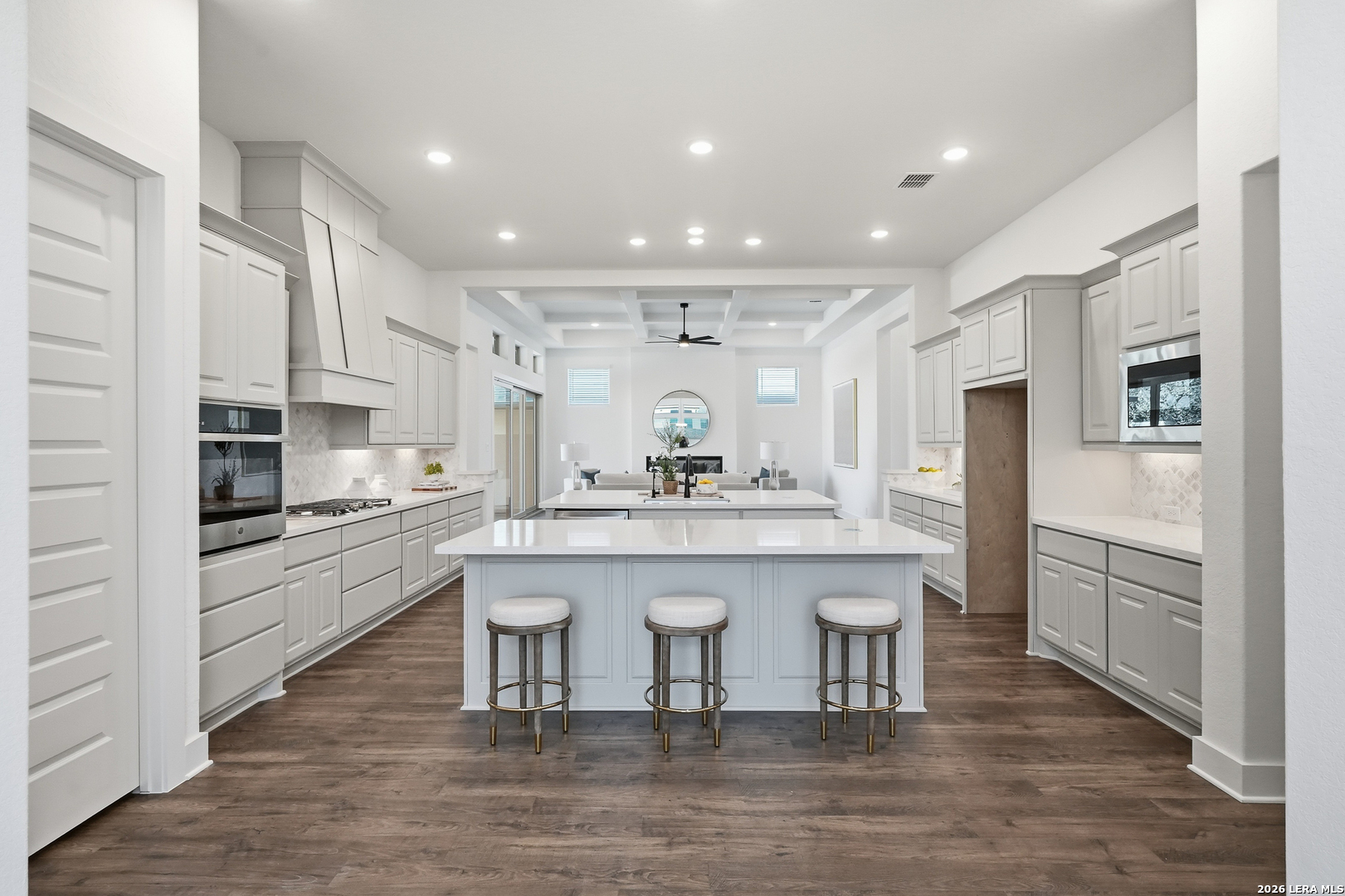 513 Corwin Springs Cibolo, TX 78108 - Photo 28 of 40 a kitchen with stainless steel appliances granite countertop a sink a stove a refrigerator and a microwave