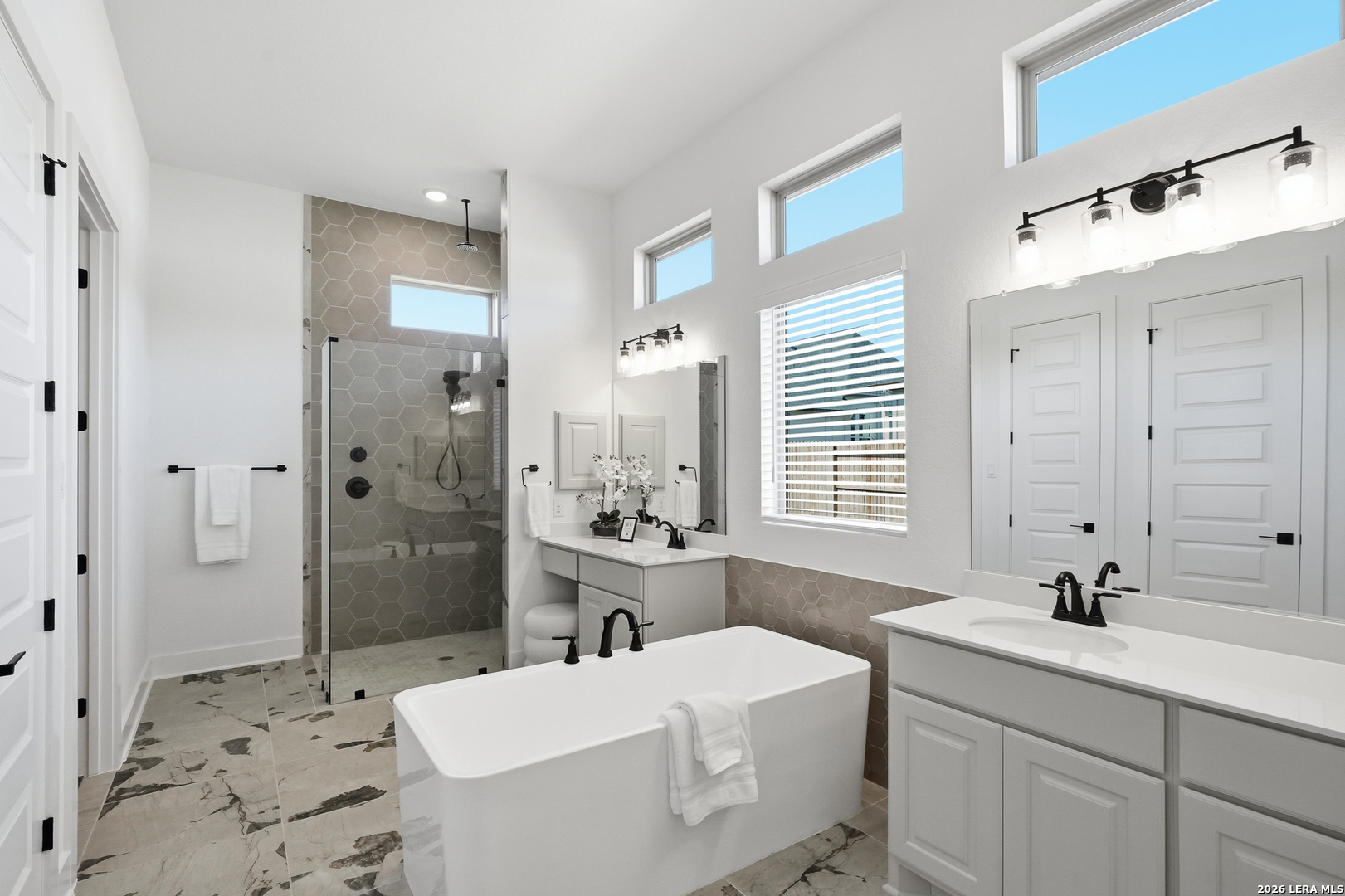 513 Corwin Springs Cibolo, TX 78108 - Photo 34 of 40 a bathroom with a sink and mirror with bathtub