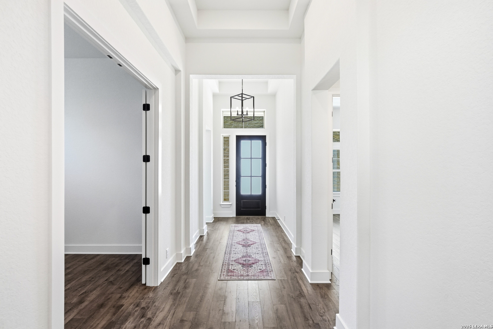 513 Corwin Springs Cibolo, TX 78108 - Photo 6 of 40 a view of a hallway with wooden floor and staircase