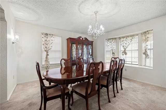 a view of a dining room with furniture window and chandelier