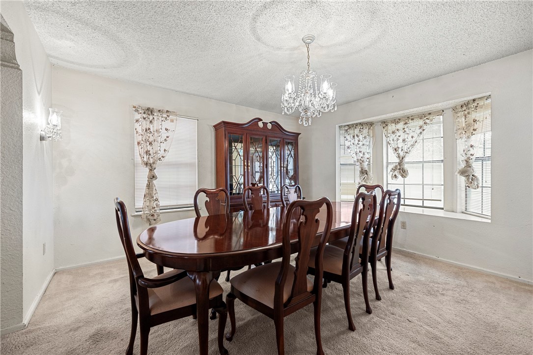 3087 Lenore Avenue Ingleside, TX 78362 - Photo 11 of 29 a view of a dining room with furniture window and chandelier