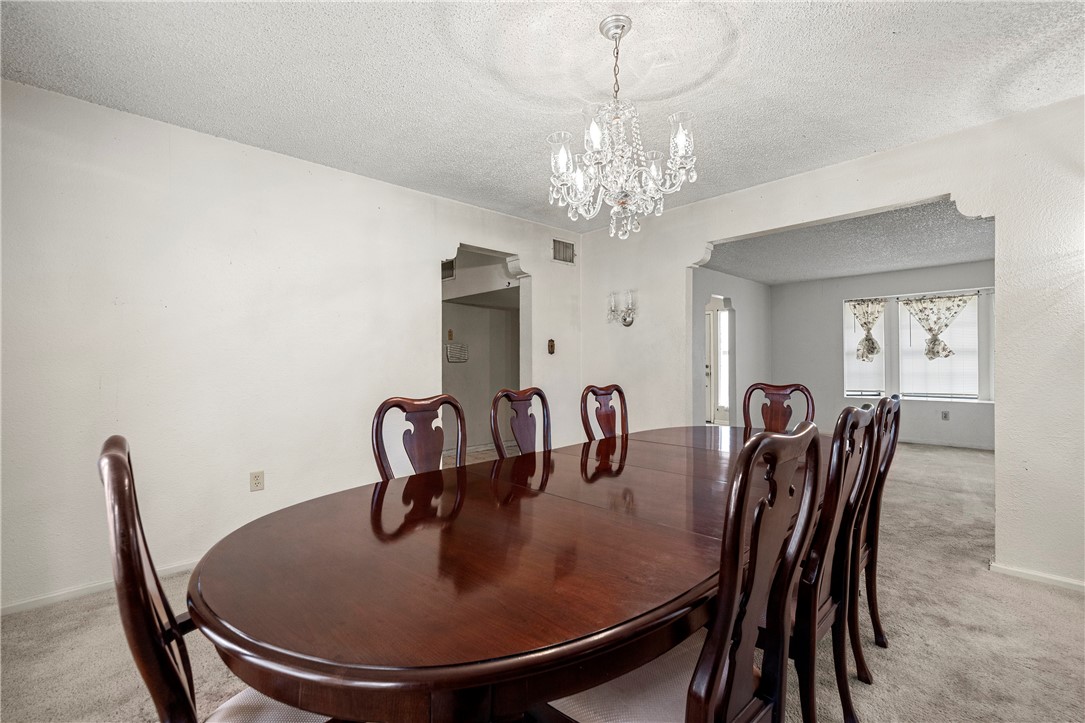 3087 Lenore Avenue Ingleside, TX 78362 - Photo 12 of 29 a dining room with furniture a chandelier and window
