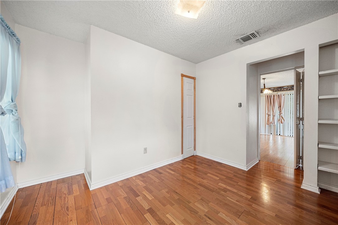 3087 Lenore Avenue Ingleside, TX 78362 - Photo 19 of 29 a view of a room with wooden floor and a window