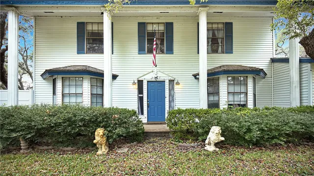 a front view of a house with a yard and outdoor seating