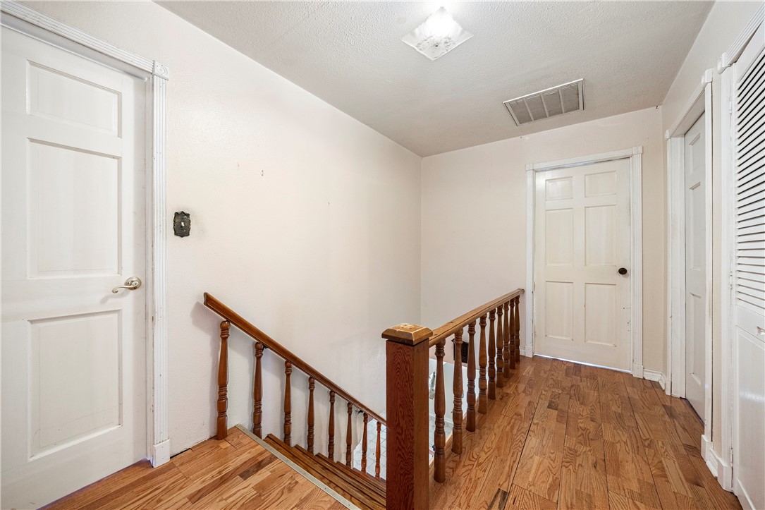 3087 Lenore Avenue Ingleside, TX 78362 - Photo 21 of 29 a view of a hallway with wooden floor and staircase