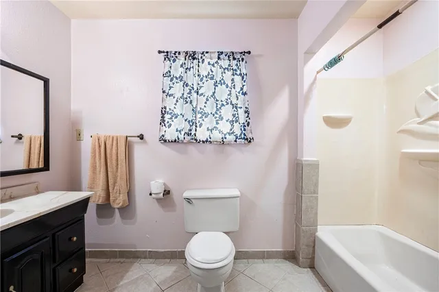 a white toilet sitting next to a bathroom sink