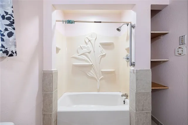 a bathroom with a bathtub and a shower