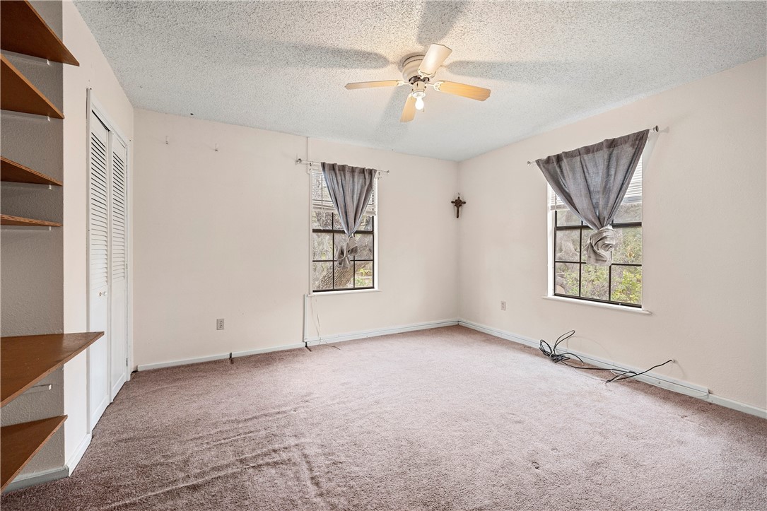 3087 Lenore Avenue Ingleside, TX 78362 - Photo 3 of 29 an empty room with windows and fan
